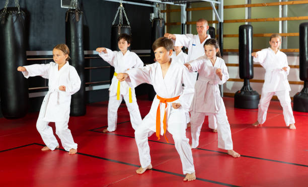 istock Kids at taekwondo workout, training attack movements 1450811673