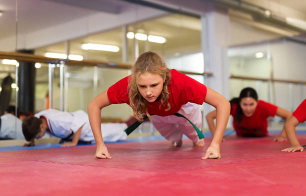 istock Preteen girl doing push-ups 1450812392