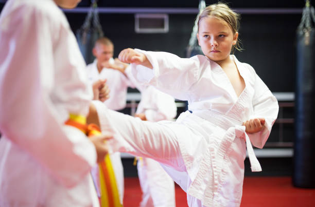 istock Girl practicing new moves during karate class 1450812457