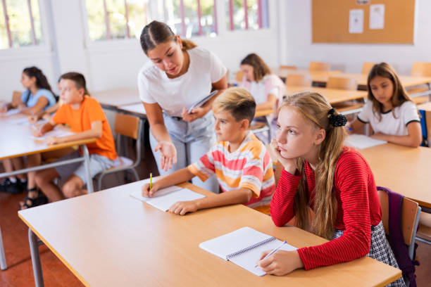istock Girl and boy exercising in classroom 1450812598
