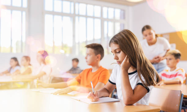 istock Girl and boy exercising in classroom 1450812599