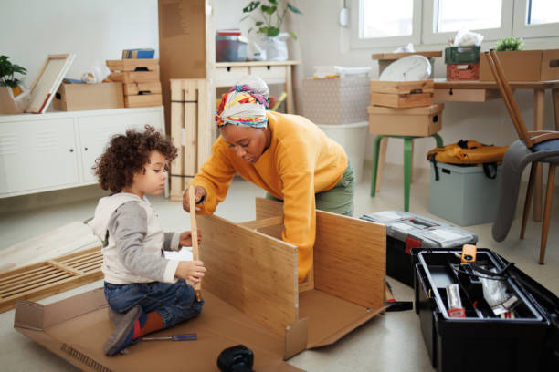 istock Mother and her cute little son assembling shelf in their new apartment 1450814155