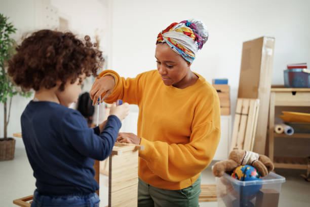 istock Mother and son assembling shelf in their new apartment 1450814214
