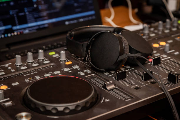 istock DJ playing music on record player, also knows as turntable in night club 1450818724