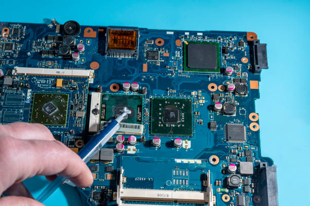 istock replacement of thermal paste in the cooling system on the laptop computer board 1450819199