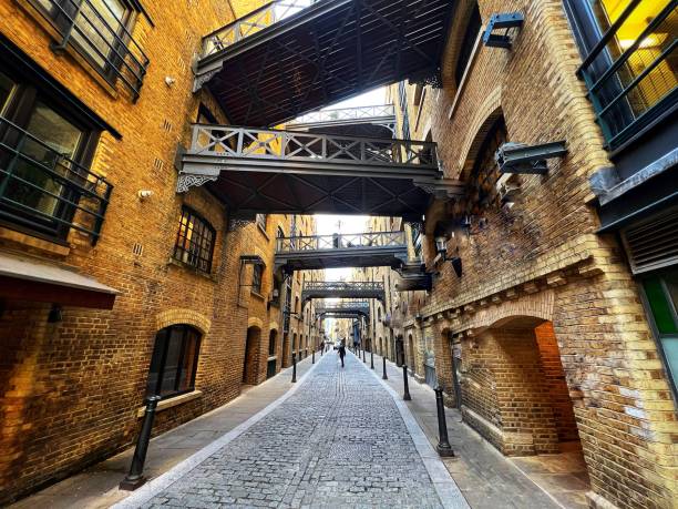 Cobblestone street of Shad Thames in London, UK The ancient cobbled street of Shad Thames on the south bank of the river Thames in London. The street is lined with gourmet restaurants and luxury apartments. bermondsey street restaurants stock pictures, royalty-free photos & images