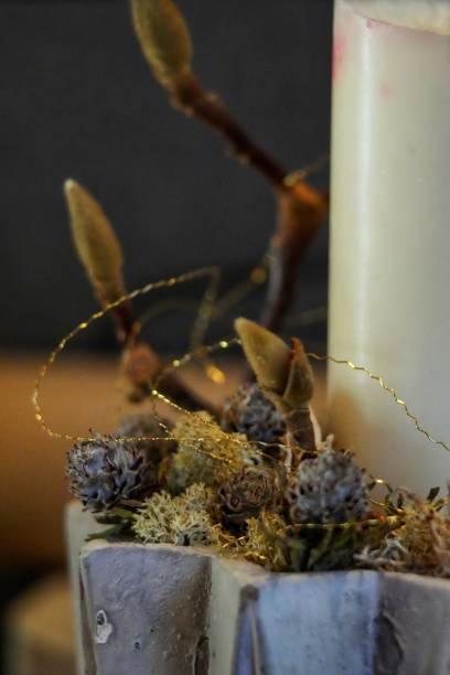 istock Vertical selective focus of a Christmas decoration with plants and a white candle 1450823732