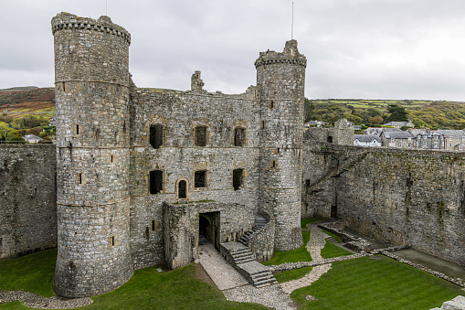 Harlech Castle is a medieval fortification built onto a rocky knoll close to the Irish Sea. Two towers flank the impressive gatehouse. It was built by Edward I during his invasion of Wales between 1282 and 1289.
