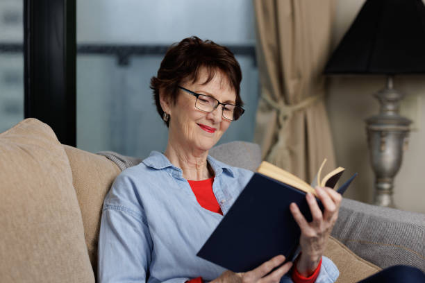 istock Smiling woman reading a book. 1450830381