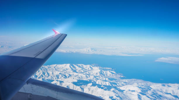 areal view from the plane over the mountain range. - mountain range earth sky airplane imagens e fotografias de stock