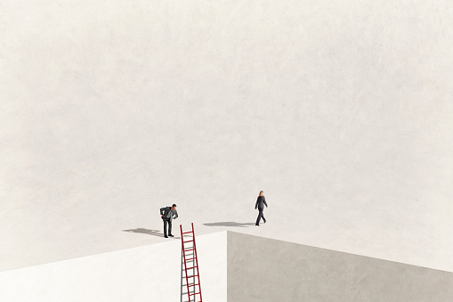 A man bends over and looks down over the edge of a precipice that has a ladder leaning against it to see if he can see where a woman, who is walking away from him, came from.
