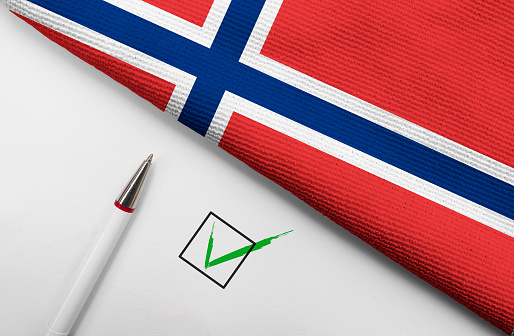 pencil, flag of Norway and check mark on paper sheet