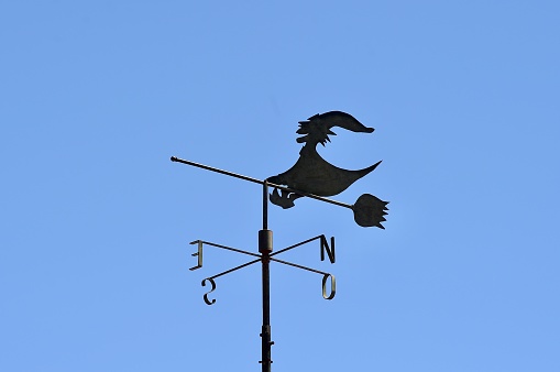 Metal blade windmill against a blue sky