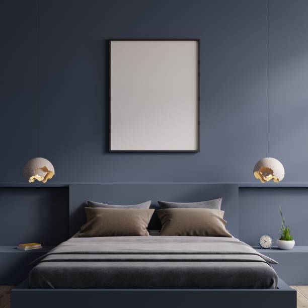 istock Poster mockup with vertical frame on empty dark blue wall in bedroom interior. 1450861193