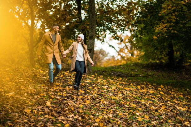 istock Happy couple having fun in autumn nature. 1450869802