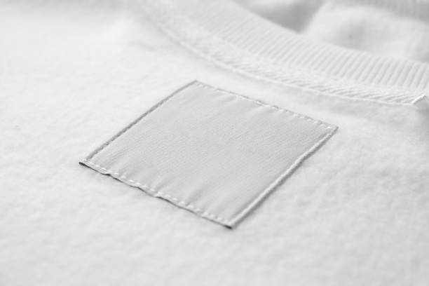 istock Blank white laundry care clothes label on fabric texture background 1450872419