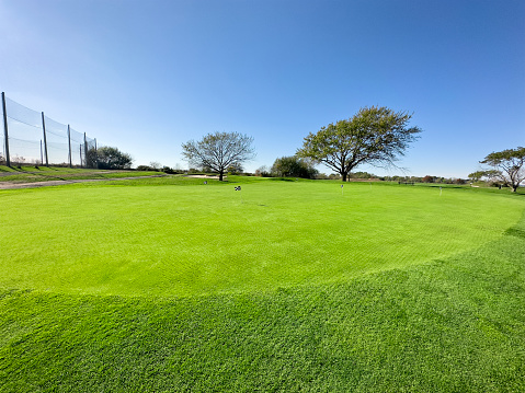 Wide angle grass golf course on a sunny day