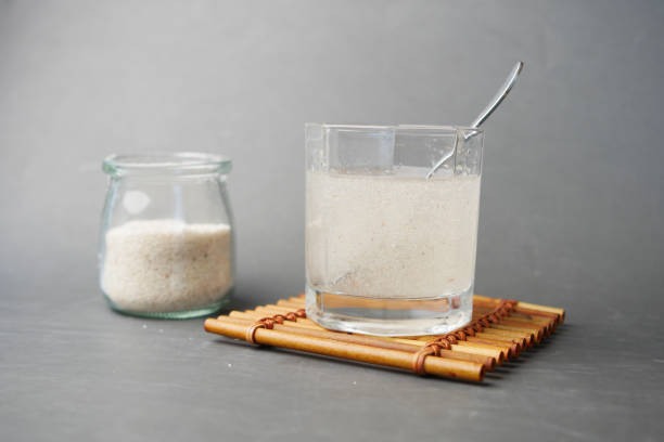 istock Wooden Spoon with Psyllium Seeds on dark background 1450889012