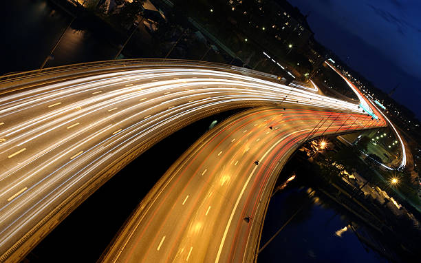 istock Moving traffic on freeway highway at night blurry speed 145089351