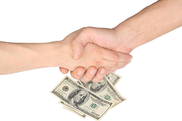 Handshake, two hands and money ($500) isolated over white background. stock photo