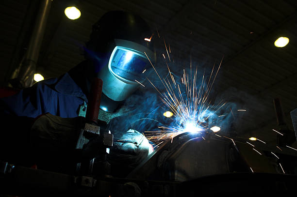 istock Welder welding a metal part in an industrial environment 145090140