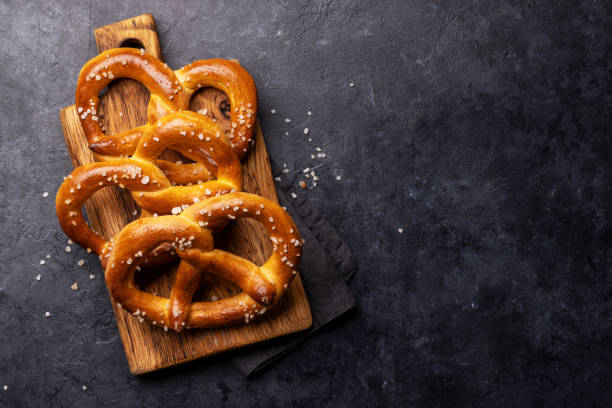 Freshly baked homemade pretzels Freshly baked homemade pretzels. Flat lay with copy space pretzel stock pictures, royalty-free photos & images