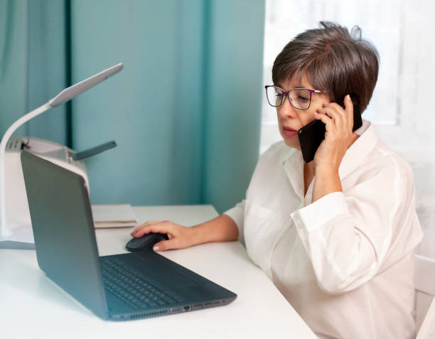 istock woman sitting at a desk with a laptop 1450920196