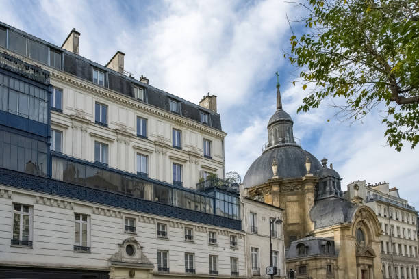 Paris, typical buildings in the Marais, rue Saint-Antoine, with the Saint-Paul church