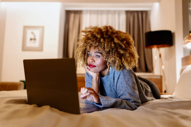 istock Businesswoman laying on bed using laptop to work late at night 1450920717