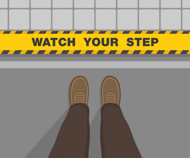 istock Man standing on the road. Watch your step warning text on the edge. Top view. 1450923711