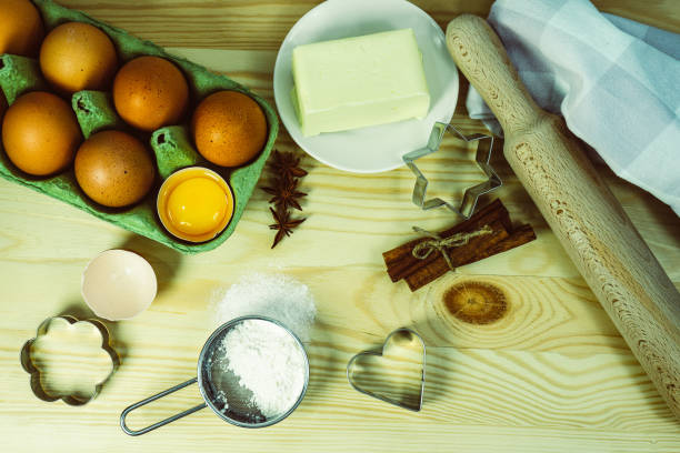 istock Background wallpaper for cooking. On the table, sprinkled with flour, there are baking tools and kitchen equipment. A set of cookie cutters of different types. 1450928981