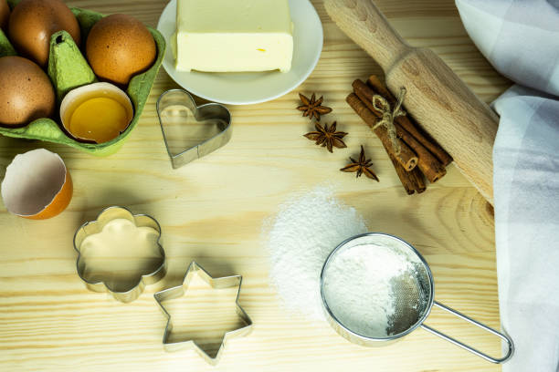 istock Background wallpaper for cooking. On the table, sprinkled with flour, there are baking tools and kitchen equipment. A set of cookie cutters of different types. 1450929625