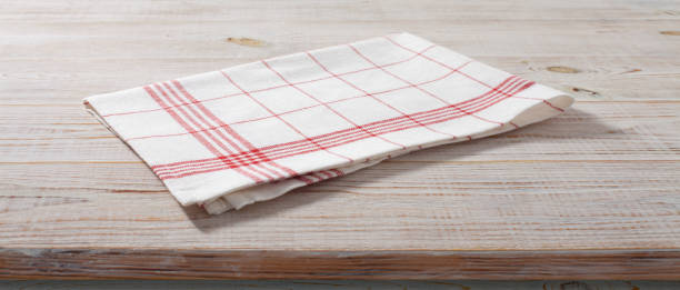 istock White napkin, table cloth on wooden deck mockup. 1450931585
