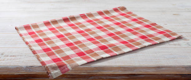 istock Folded towel, linen tablecloth on wooden desk perspective. Selective focus. 1450931599