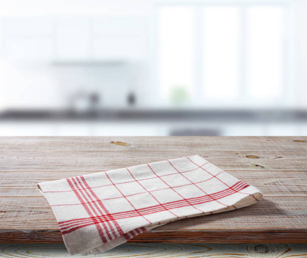 istock White napkin, table cloth on wooden deck mockup. Kitchen interior background 1450932153