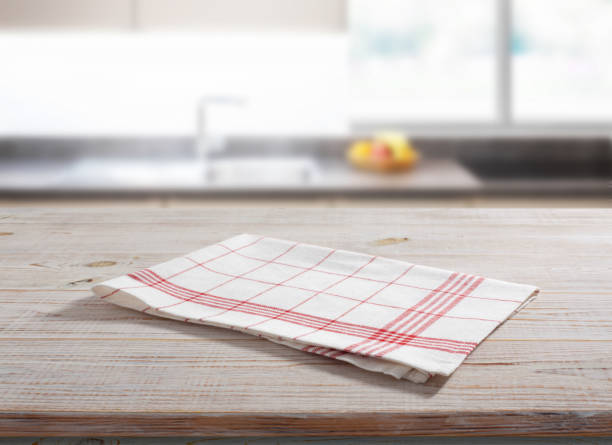 istock White napkin, table cloth on wooden deck mockup. Kitchen interior background 1450932157