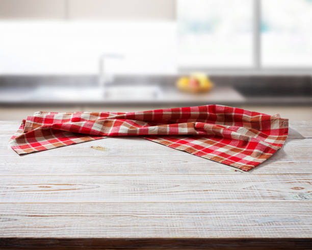 istock Crumpled linen tablecloth on wooden desk perspective. Selective focus. 1450932180