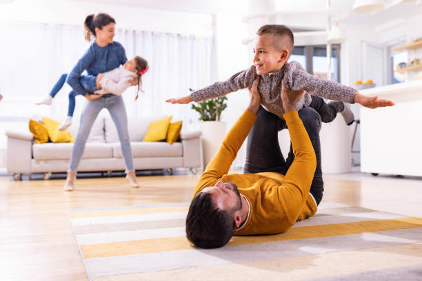 istock Playful parents having fun with their kids at home. 1450937102