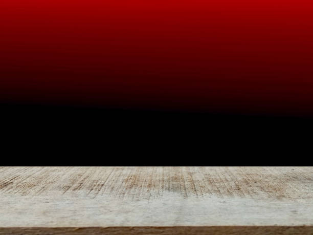 istock empty brown wooden table  red black gradient backdrop  design template for product presentation, advertisement 1450937594