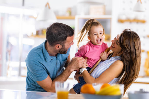 istock Young cheerful family having fun together in dining room. 1450937792