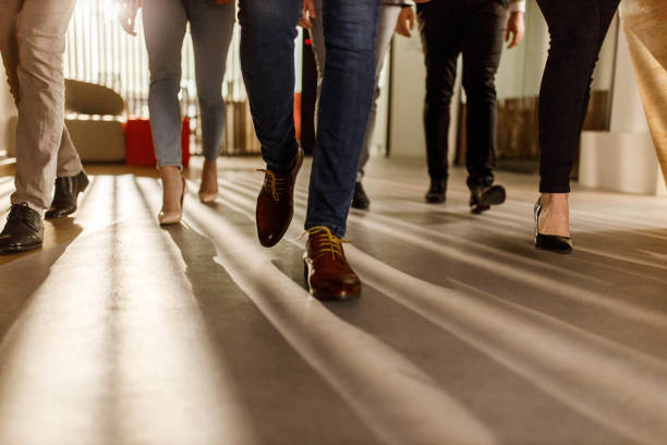 istock Unrecognizable business people walking in a lobby. 1450938916