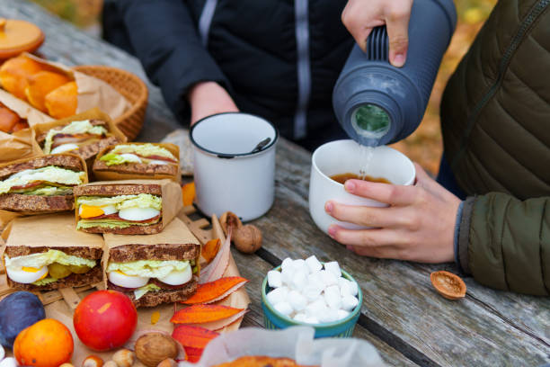 https://media.istockphoto.com/id/1450960376/photo/picnic-in-the-autumn-season-food-on-a-wooden-table-hot-tea-pastries-and-sandwiches.jpg?s=612x612&w=0&k=20&c=fHSV8m19sSWwlYIw4ErSnfGpCKS7N7JduBTLmBbSKXA=