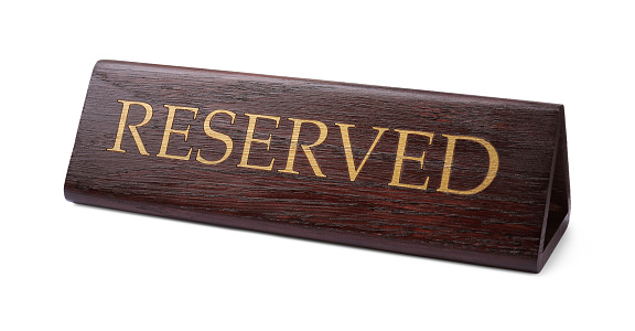 Elegant wooden Reserved table sign isolated on white