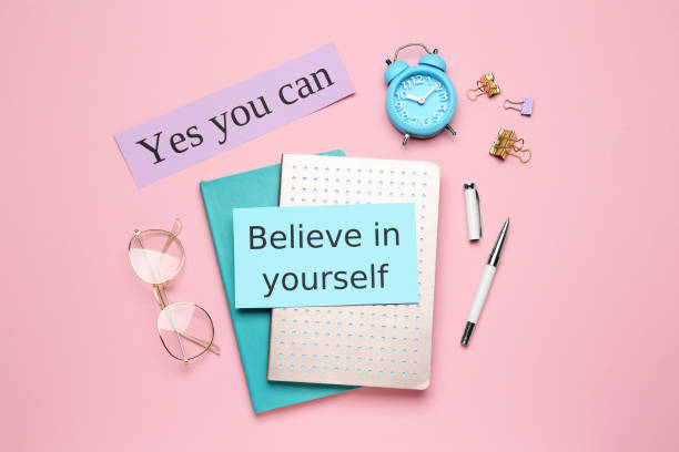 istock Notes with motivational quotes, glasses and office stationery on pink background, flat lay 1450960848