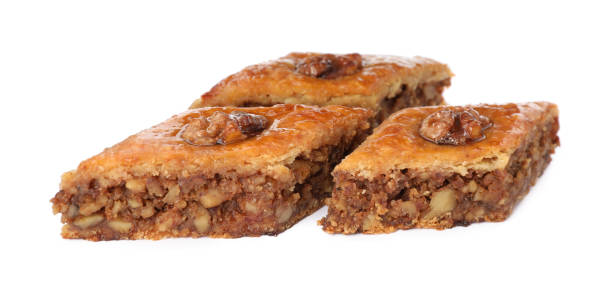 istock Delicious honey baklava with walnuts on white background 1450960907