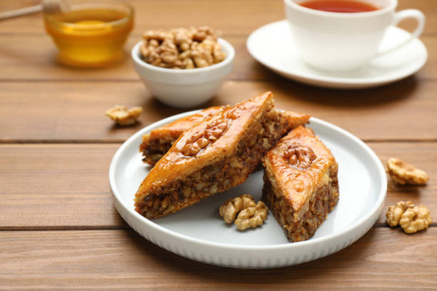 istock Delicious honey baklava with walnuts served on wooden table 1450961193