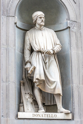 Donatello (1386-1466) was an Italian Renaissance sculptor from Florence. Here in this sculpture he is seen in the open public space of the Uffizi Colonnade. The sculpture was created by Girolamo Torrini and Giovanni Bastianini in 1848.