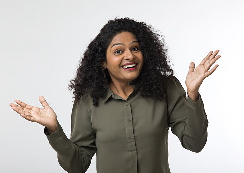 Portrait of woman gesturing with open hand palms on white background