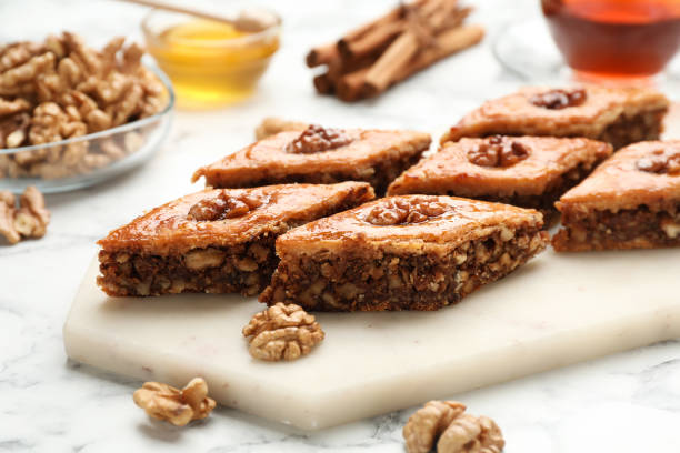 istock Delicious honey baklava with walnuts on served white marble table, closeup 1450964524