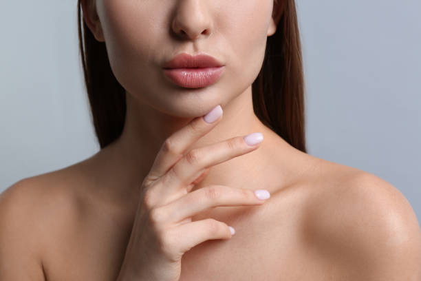 istock Woman with beautiful lips on light grey background, closeup 1450964683
